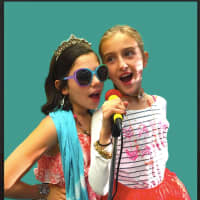 <p>Two participants in the ‘Vocal Divas’ Workshop, where 7-12 year olds learn all things related to singing and enjoy incorporating contemporary music of various genres</p>