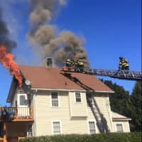 <p>In an image from the Norwalk Fire Department Facebook page, firefighters are seen battling a blaze at 2 Platt St. No one was hurt in the fire in the multifamily home.</p>