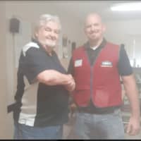 <p>Mike Finn, director of the New Street Homeless Shelter in Danbury, shakes hands with Todd Wingard, manager of Lowe&#x27;s of Danbury</p>