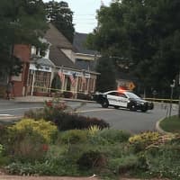 <p>A New Castle Police car is pictured next to Lange&#x27;s, a popular deli in Chappaqua, following a shooting on Monday morning.</p>