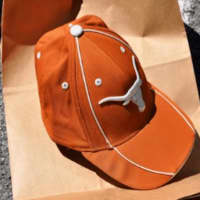 <p>The suspect dropped an orange University of Texas Longhorns baseball cap.</p>