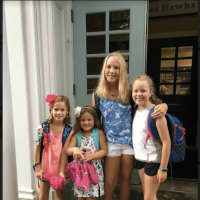 <p>Second grader Molly FitzGerald, kindergartener Mae Barnard, and fifth graders Bridget FitzGerald and Sarah Williams about to start their first day at Holmes School</p>