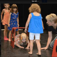 <p>DAC Kids’ Theatre Director Heather Kahlert leads an introductory mini-class for the younger set at the Open House.</p>