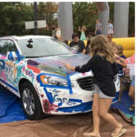 <p>Volvo of Westport donated a car for kids to paint at an area staffed by high school students who participate in Builders Beyond Borders, a group that raises money and makes annual trips to places such as Latin America.</p>