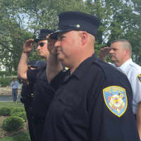 <p>New Canaan firefighter Michael Tiani saluting during the 9/11 memorial event in front of New Canaan Town Hall Friday morning.</p>