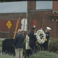 <p>Danbury Fire Chief TJ Wiedl and Danbury Police Chief Patrick Ridenhour place the wreath on the Sept. 11 Memorial.</p>