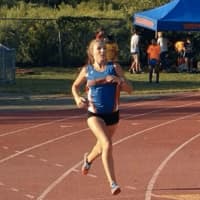 <p>Danbury&#x27;s Lauren Moore takes first place in the Girls Cross Country Varsity race</p>