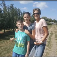 <p>Monroe resident Susan Napolitano with Maddy, 13, and Jackson, 10, at Blue Jay Orchards in Bethel</p>