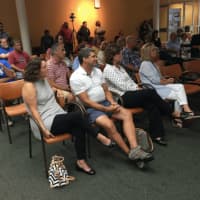<p>Audience members listening to Laura Simon, wildlife ecologist for the Humane Society of the United States speaking about coyotes in Stamford on Tuesday.</p>