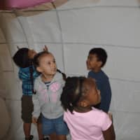 <p>Preschool children from the new Maritime Odyssey Preschool in Norwalk, inside an inflatable life-sized humpback whale</p>