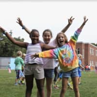 <p>Naomie Joseph, Esther Bittker and Eloise Mallie show their school spirit with Holmes shirts and big smiles during the third-grade walk.</p>