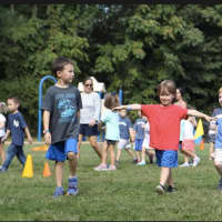 <p>Kindergartners Kyle Cheng, Dylan Danile and Jack McKay take part in their first walkathon.</p>