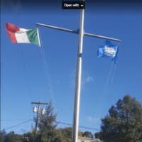 <p>The Italian flag going up in honor of Columbus Day on Monday in Bethel</p>