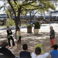 <p>Lilian Fortino of the Norwalk Housing Authority, Kimberly Castillo, and Susan Wallerstein of the Norwalk Arts Commission talk with students during a walking tour of art.</p>