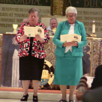 <p>Blauvelt Dominican Sisters Carol Carullo, left, and Dorothy Maxwell, right, renew their vows at their Golden Jubilee Liturgy.</p>