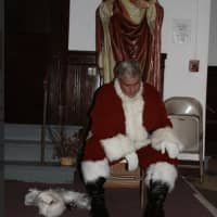 <p>Al DiGuido returning to street clothes after one of his Santa visits to children in Stamford.</p>