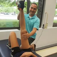 <p>Patrick Buckley of Trumbull works with a patient at Dynamic Edge PhysioTherapy in Wilton, which opened in July.</p>