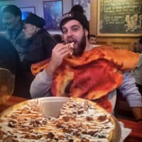 <p>Pizza Man Dan chows down at Grant Street Cafe in Dumont.</p>
