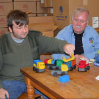 <p>Luke and Jim Barber, of Luke&#x27;s Toy Factory in Danbury, showing their line of toy trucks</p>
