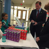 <p>Sen. Richard Blumenthal and his wife prepare to buy Girl Scout cookies from sisters Sarah, left, and Isabella, right, just prior to voting at Glenville School in Greenwich.</p>