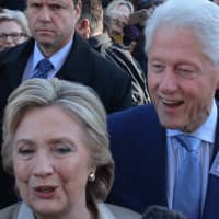 <p>Hillary and Bill Clinton walk by supporters and reporters in front of Douglas G. Grafflin Elementary School in Chappaqua after casting their presidential votes.</p>