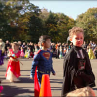<p>Drew Chua and Calvin Briggs march with their classmates in the Holmes School Halloween parade on Monday, Oct. 31.</p>