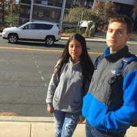 <p>Stamford High students Mariana Jimenez and Fabio Luco, stand on the sidewalk in front of Stamford High School. The markings on Strawberry Hill Avenue show where a crosswalk will be located. The city is putting the crosswalk following a student death.</p>