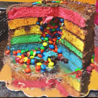 <p>Rainbow cake with M&amp;M&#x27;s and chocolate frosting at REBakery.</p>