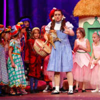 <p>Dorothy (Kate Murphy) and munchkins in cast of &quot;The Wizard of Oz&quot; at New Canaan High School.</p>