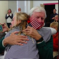<p>Fourth-grader Whitney Grunow hugs her grandfather John O. Wolcott, who served in the Army for three years in Vietnam and in the Army Reserves for three years.</p>