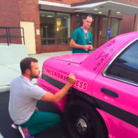 <p>Hospital officials leave their mark on Pink Heals&#x27; cruiser.</p>
