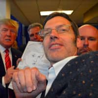 <p>Political cartoonist and caricature artist and Darien resident Bob Carley presenting his caricature to president-elect Donald Trump</p>