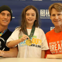 <p>Connor Dwyer (L) and Josh Davis (R) share their hardware with young swimmers at Saw Mill Club.</p>