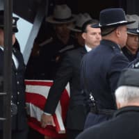 <p>Pallbearers bring out the casket of Putnam County Undersheriff Peter Convery following his funeral inside a Mahopac church.</p>