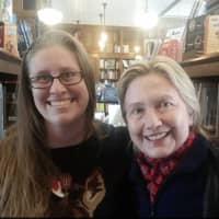 <p>Hillary Clinton at The Savoy Bookstore in Waverly, Rhode Island, on Sunday with store employee Jessica Wick.</p>