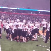 <p>Somers football players moments after securing the win at the Carrier Dome in Syracuse.</p>