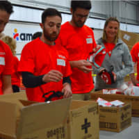<p>One by one, in assembly line fashion, about 30 volunteers from Voya Financial assembled first aid kits on Tuesday morning at Americares headquarters in Stamford, to celebrate Giving Tuesday.</p>