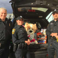 <p>From left, Lt. Terry Blake, and officers Sara Laudano and Keith Torreso at the Norwalk Police Department&#x27;s Stuff A Cruiser toy drive at Toys &#x27;R Us on Friday.</p>