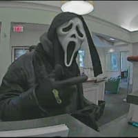 <p>This suspect in  Halloween mask robbed the First County Bank on Main Avenue Tuesday afternoon. The suspect is captured on a bank video surveillance in an image released by Norwalk Police.</p>