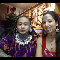 <p>The creator of the Standing Rock tattoo, Stephanie Big Eagle (right), shows off the finished design.</p>