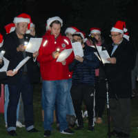 <p>Members of the Sacred Heart University choir sings Christmas carols next to the tree on the West Campus.</p>