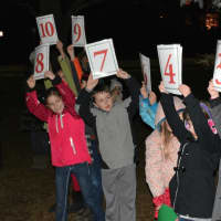 <p>Kids hold up countdown signs for Bedford Village&#x27;s Christmas tree lighting.</p>