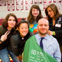 <p>Bethel High School music teacher Richard Baumer shows off his new look, along with students and a hairdresser from Escape Salon and Spa in Bethel.</p>