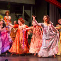<p>Bob Williams and Lisa Uffer (Mr. and Mrs. Fezziwig) look on as Mia Martovich, Katie Kenyhercz, Maddy Oldham (as Charlotte Fezziwig), Devin Murphy, Brianna Bowman, Cailee Harvey and Ali Bratter dance at the Fezziwig Ball.</p>