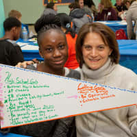 <p>Ninth-grader Agyeiwa Okodie and her graduation coach, Susan Roth, hold a banner showing the student&#x27;s goals at a recent Yonkers Partners in Education event celebrating incoming program participants.</p>