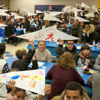 <p>Young scholars hold up their “vision banners” at a recent Yonkers Partners in Education event. The banners detail the students&#x27; goals for both high school and college.</p>