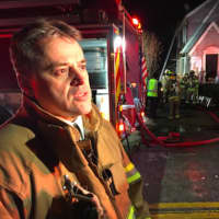 <p>Assistant Fire Chief Mike Robles speaking at the scene of a fire at 26 Underhill St. in Stamford.</p>