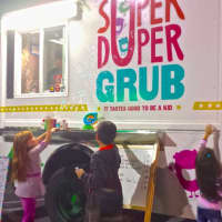 <p>Kids clamor around a bubble machine at Super Duper Grub.</p>