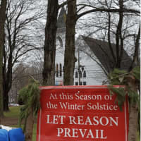 <p>Jerry Bloom put up a banner celebrating the Winter Solstice on the Huntington Green in Shelton. It was recently slashed by vandals and has been taken down.</p>