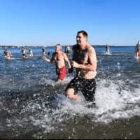 <p>Participants make a quick splash in the frigid waters of Long Island Sound on New Year&#x27;s Day.</p>